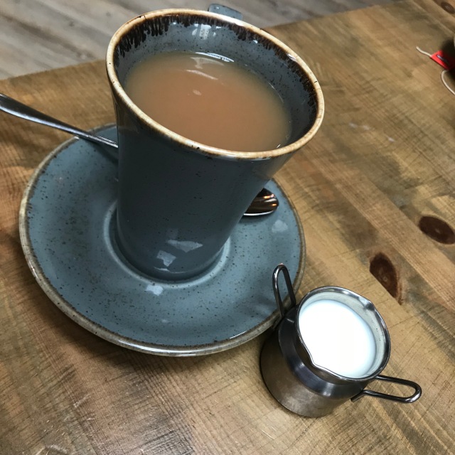 mug of tea and milk in a little jug
